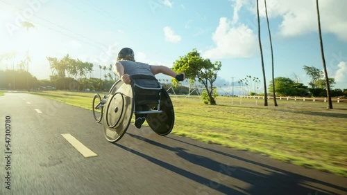 Disabled wheelchair paralympic athlete in wheelchair racing chair outside working out healthy lifestyle