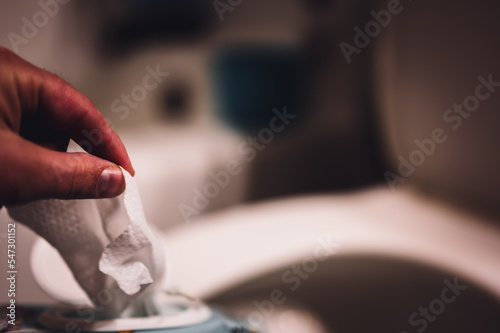 Disposable wipes being flushed down a toilet where they can cause clogging and problems with wastewater treatment. photo