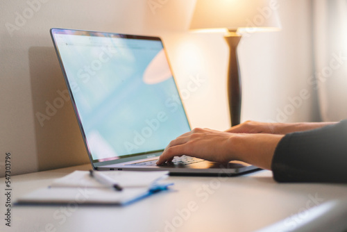 Girl typing on keyboard at home office 