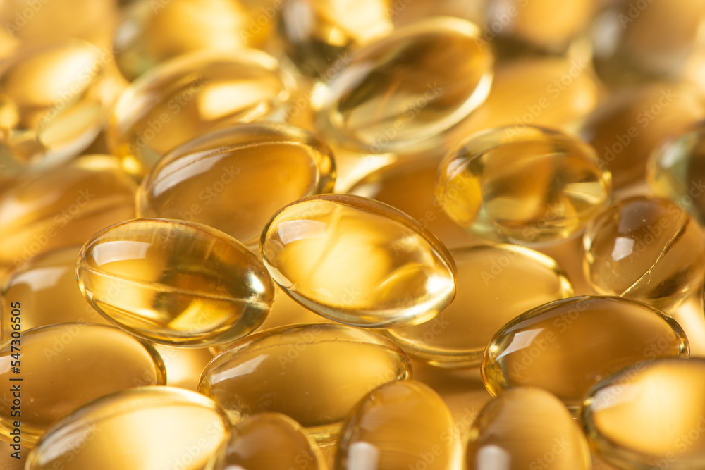 Vitamin E Supplementary food. Omega 3. Gold fish oil gel Capsules background. Vitamin E Supplementary food. Omega 3. Gold fish oil gel Capsules background.