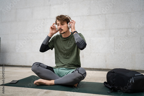 one man doing guided meditation online yoga self care concept outdoor