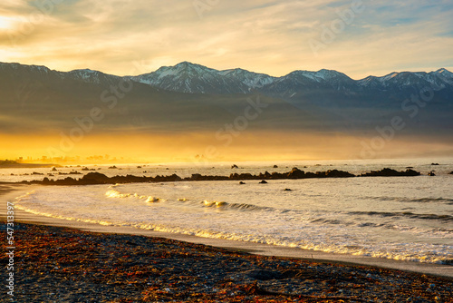 Kaikoura bay lit up by warm sunshine in the late afternoon with the snow capped Mountains in the background photo
