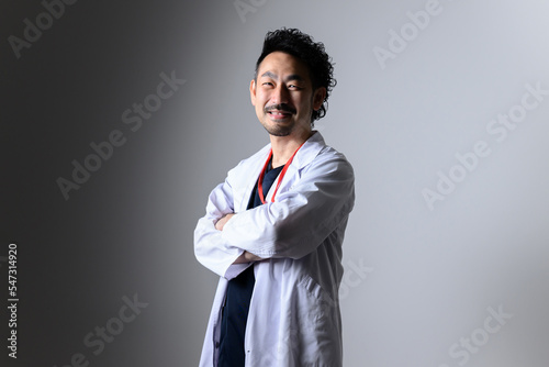 For hiring, changing jobs, etc. Image of a mid-level Asian male doctor wearing a white coat. photo