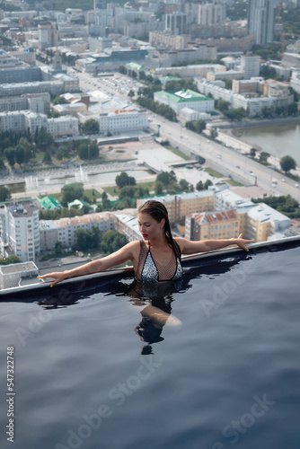 Woman in swimming pool on roof