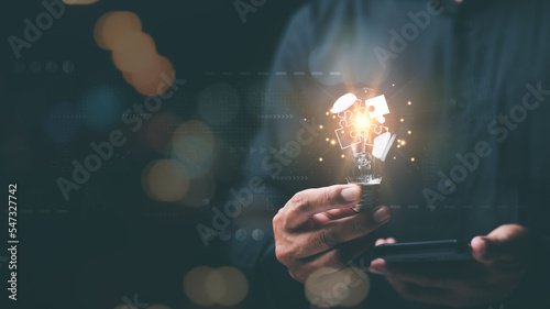 solution concept and demonstrating leadership strategies,Creativity that will lead the business in the right direction,with innovation and brain power from brainstorming,man holding a light bulb