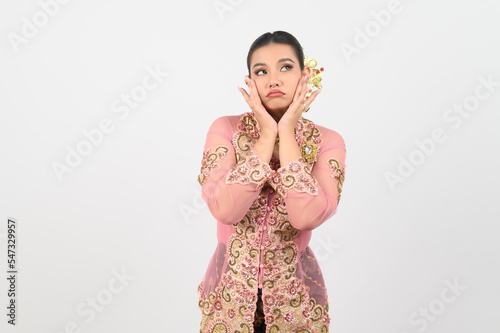 Young beautiful woman dress up in local culture in southern region with thoughtful posture