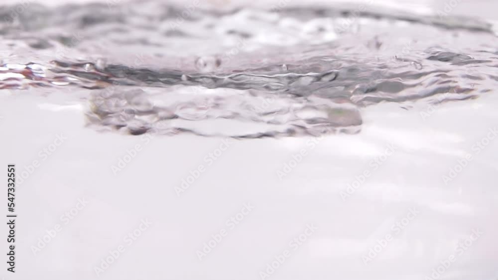 Close-up of boiling water with bubbles rising above in slow motion. Close-up of boiling water with bubbles rising above in slow motion.