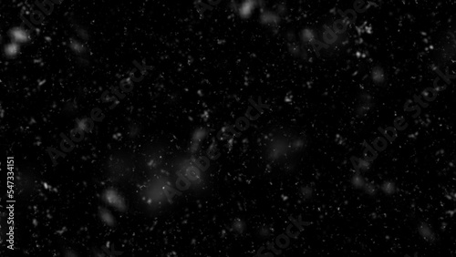 Falling snow flakes, Flying dust particles on a black background. Abstract winter background. Winter landscape with falling shining beautiful snow. 