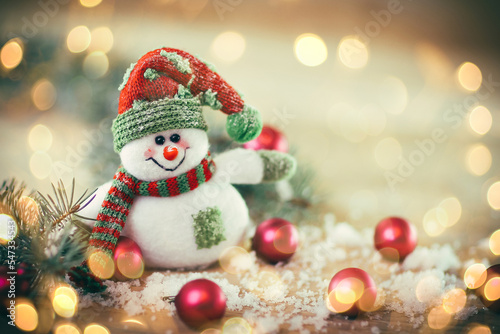 Christmas card. toy snowman on a festive background.