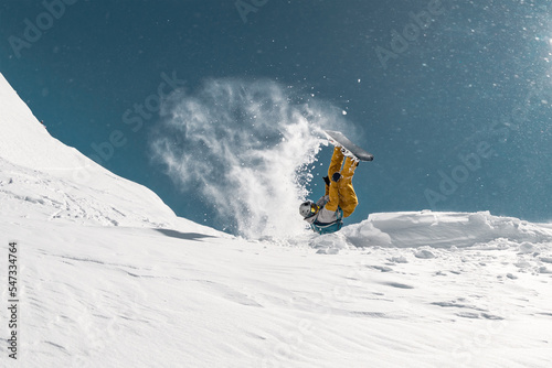 Snowboarder make jump and flip at ski resort. Extreme winter sports
