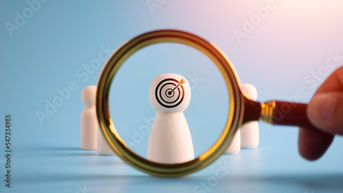 Magnifier glass focus on Target dartboard on head human wooden, business development strategy, and action plan concept, search, goal, strategy, success and leadership