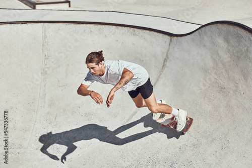 Skateboard, ramp and man skating at a park for exercise or practice at an urban city in Canada. Fitness, adventure and athlete skater doing skateboarding trick while training for a sports competition