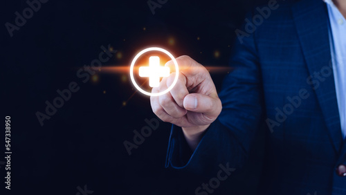 Businessman touching offer positive thing such as profit, benefits, development, CSR represented by plus sign.The hand shows the plus sign.(e.g. personal development benefits, social network