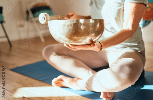 Yoga, tibetan bowl and hands of woman in meditation, sound therapy and healing with zen, ambient and peace on a floor. Wellness, singing bowl and lady practice mind, energy and inner peace in India