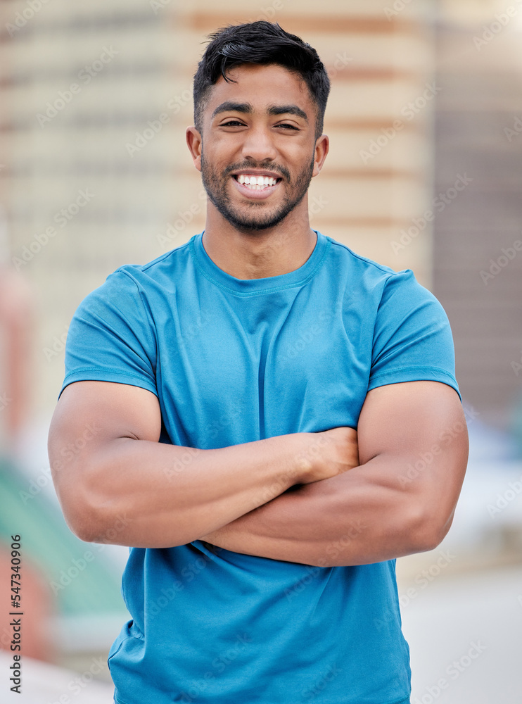 Foto Stock Fitness, exercise and portrait of a sports man standing arms  crossed outdoor with a smile on his face. Workout, health and happy with a  male athlete training outside for cardio