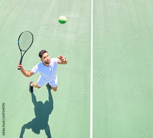 Tennis, mockup and serve with a sports man playing a game on a tennis court outoor from above. Fitness, sport and exercise with a male tennis player hitting a ball during a game or match outside © Irshaad M/peopleimages.com