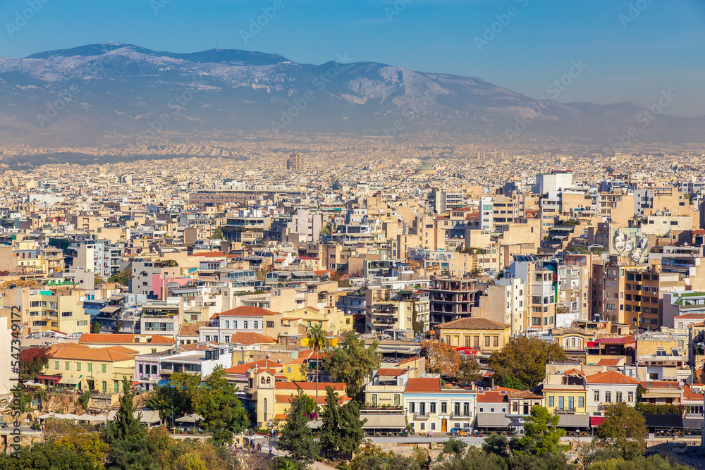 Residential Homes in a Historic City with Cityscape and Mountains in Background. Areopagus Hill, Athens, Greece.