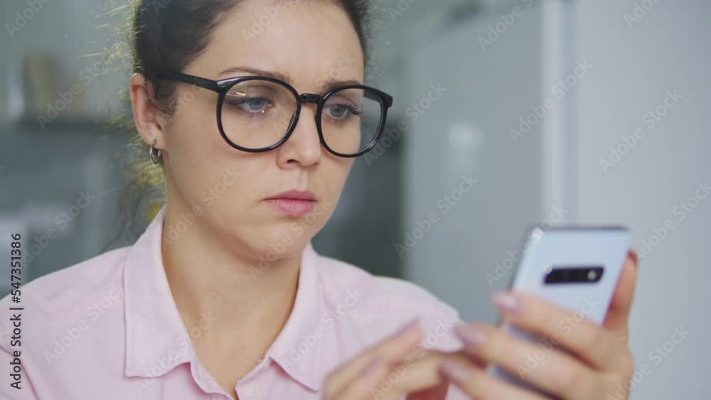 Young woman is worried, forget password and can't unlock her smartphone, bugs Young woman is worried, forget password and can't unlock her smartphone, bugs