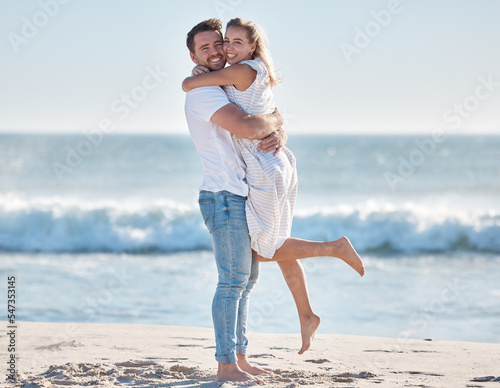 Hug, happy and couple at the beach for love, peace and relax on a tropical holiday in Hawaii. Freedom, travel and portrait of a man and woman hugging by the ocean excited about a vacation in summer