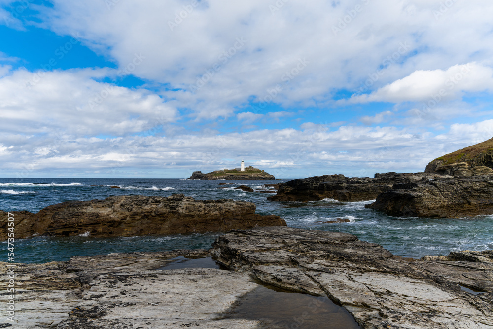 rocky Cornwall coast with the Godrevy Lighthouse behind