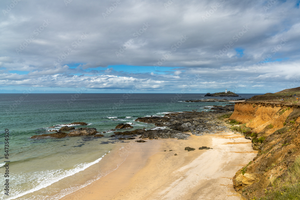 view of St. Ives Bay and small beach near Gwithian with the Godrevy Lighthouse in the background