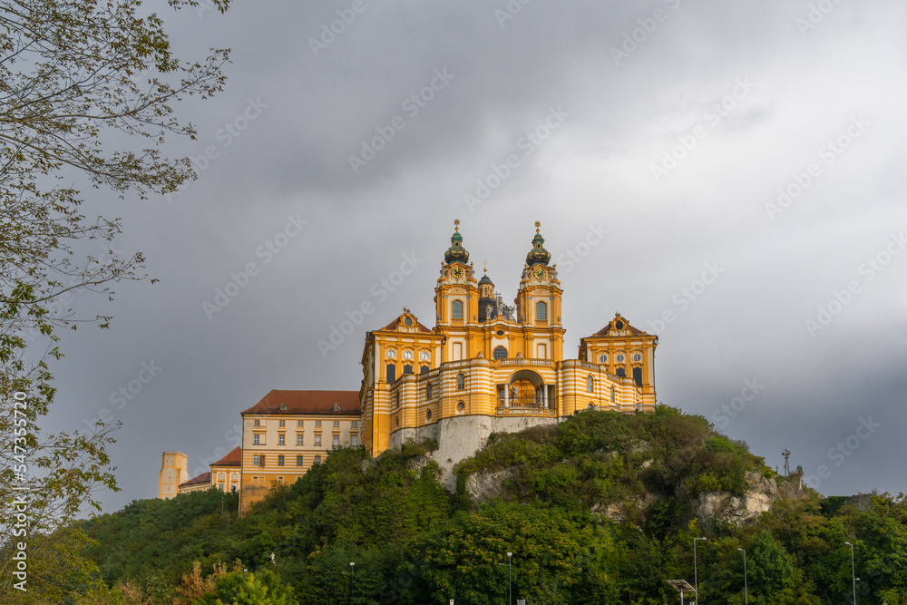 the historic Melk Abbey and church spires on the rocky promontory above the Danube River
