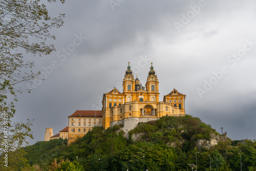 the historic Melk Abbey and church spires on the rocky promontory above the Danube River