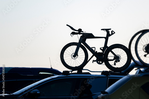 Silhouette image of bikes on car rooftop rack. Auckland.