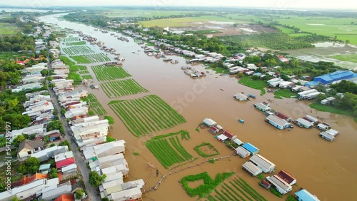 Floating village along Hau river over Vietnam border area, aerial view. The river basin contains a lot of seafood and alluvium for agriculture and economic development in the Mekong Delta