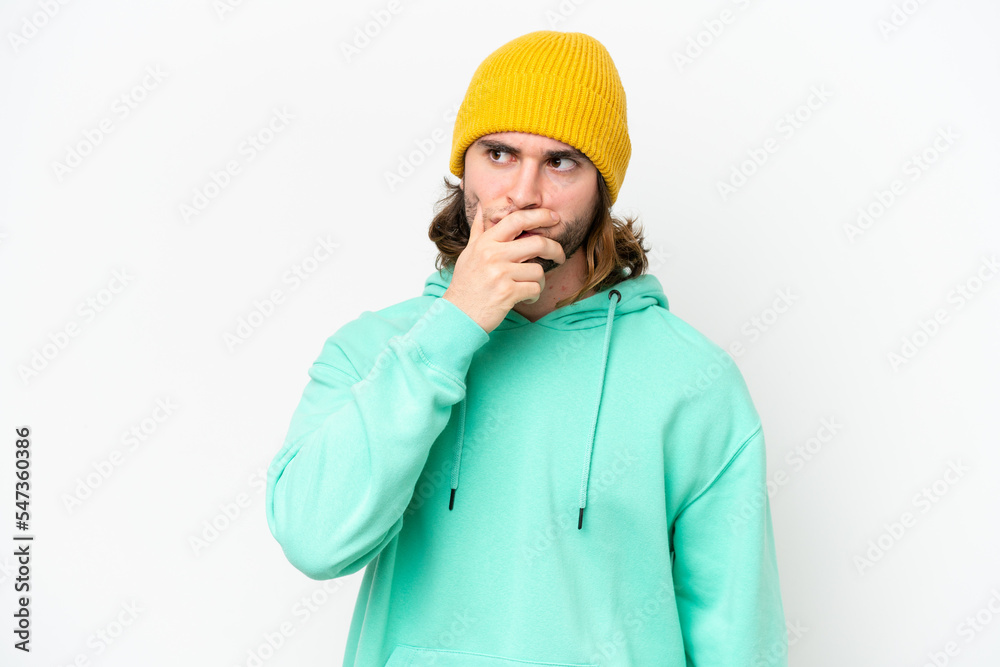Young handsome man isolated on white chroma background having doubts and with confuse face expression Young handsome man isolated on white chroma background having doubts and with confuse face expression