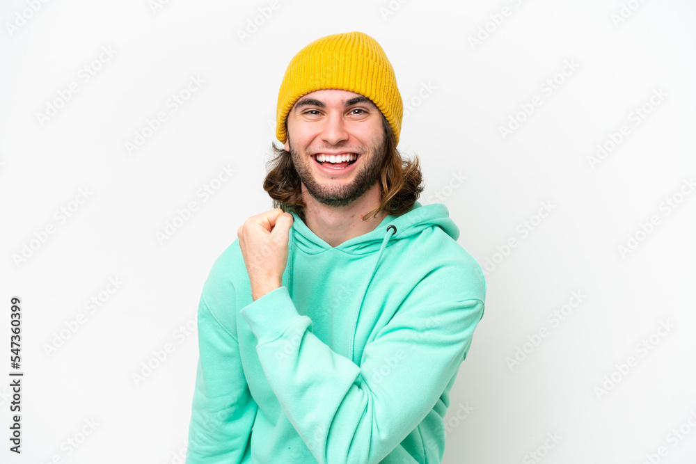 Young handsome man isolated on white chroma background celebrating a victory Young handsome man isolated on white chroma background celebrating a victory