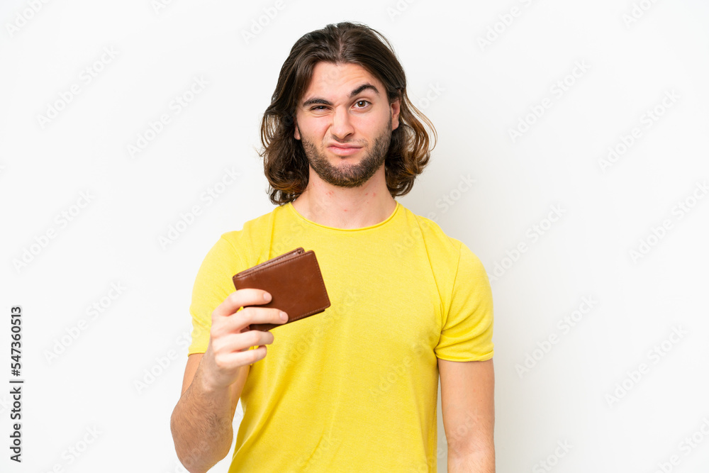 Young handsome man holding a wallet isolated on white background with sad expression Young handsome man holding a wallet isolated on white background with sad expression