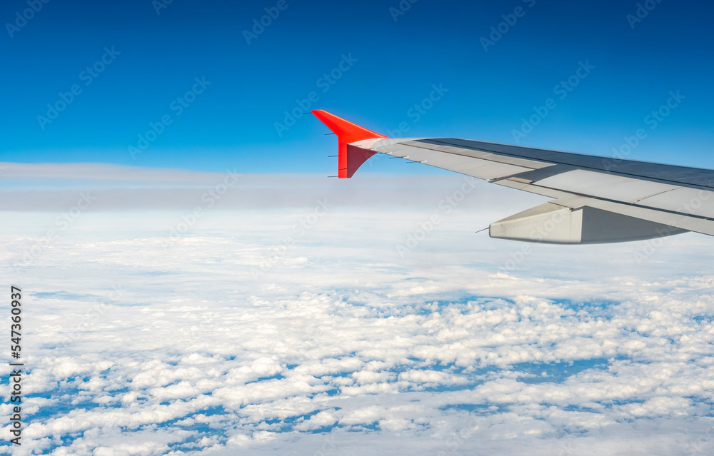 Obraz premium airplain wing over the clouds