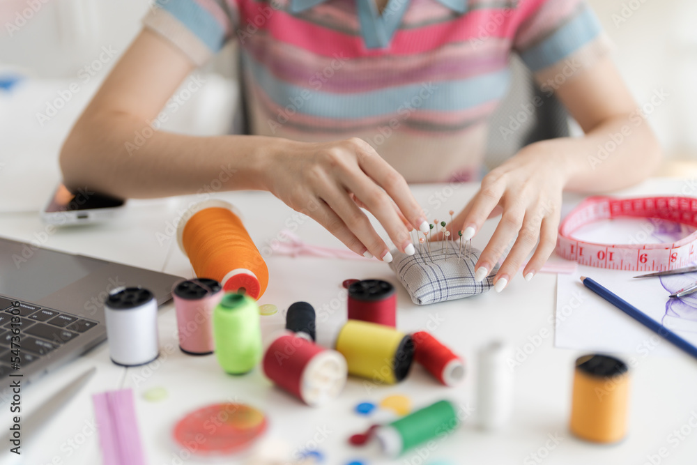Cropped image of young beautiful designer working with sketches and tools. Cropped image of young beautiful designer working with sketches and tools.