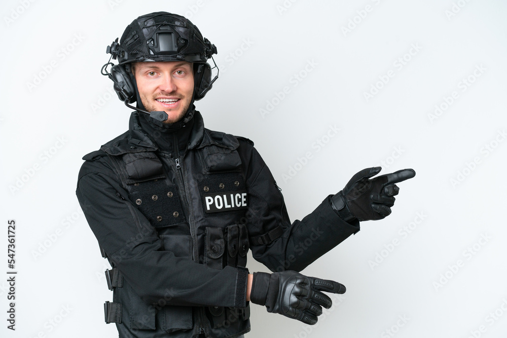 SWAT man over isolated white background pointing finger to the side and presenting a product SWAT man over isolated white background pointing finger to the side and presenting a product