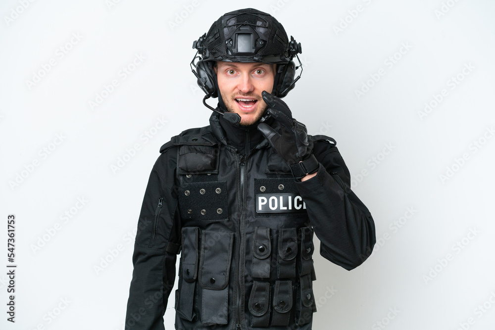 SWAT man over isolated white background with surprise and shocked facial expression SWAT man over isolated white background with surprise and shocked facial expression