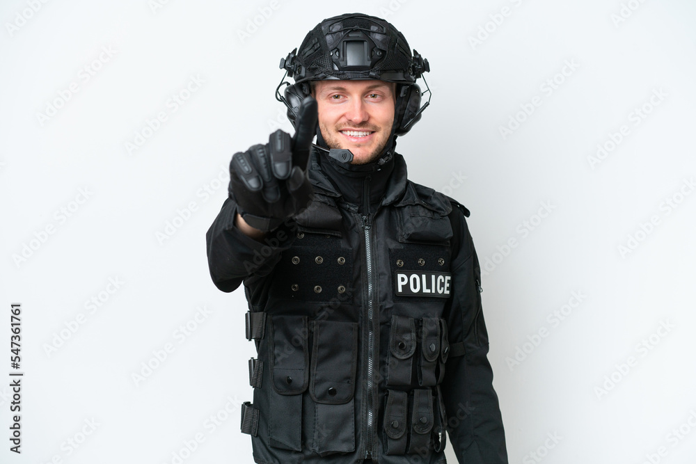 SWAT man over isolated white background showing and lifting a finger SWAT man over isolated white background showing and lifting a finger