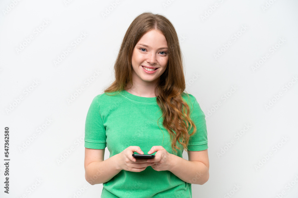 Young pretty woman isolated on white background sending a message with the mobile Young pretty woman isolated on white background sending a message with the mobile