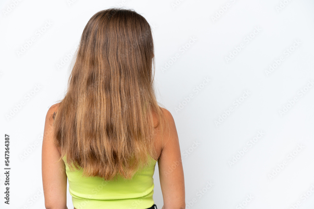 Young caucasian woman isolated on white background in back position and looking side Young caucasian woman isolated on white background in back position and looking side