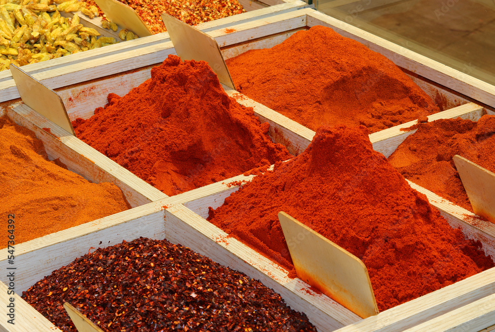red paprika powder and other exotic spices for sale at the market