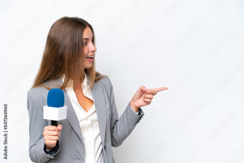 Young TV presenter caucasian woman isolated on white background pointing finger to the side and presenting a product Young TV presenter caucasian woman isolated on white background pointing finger to the side and presenting a product