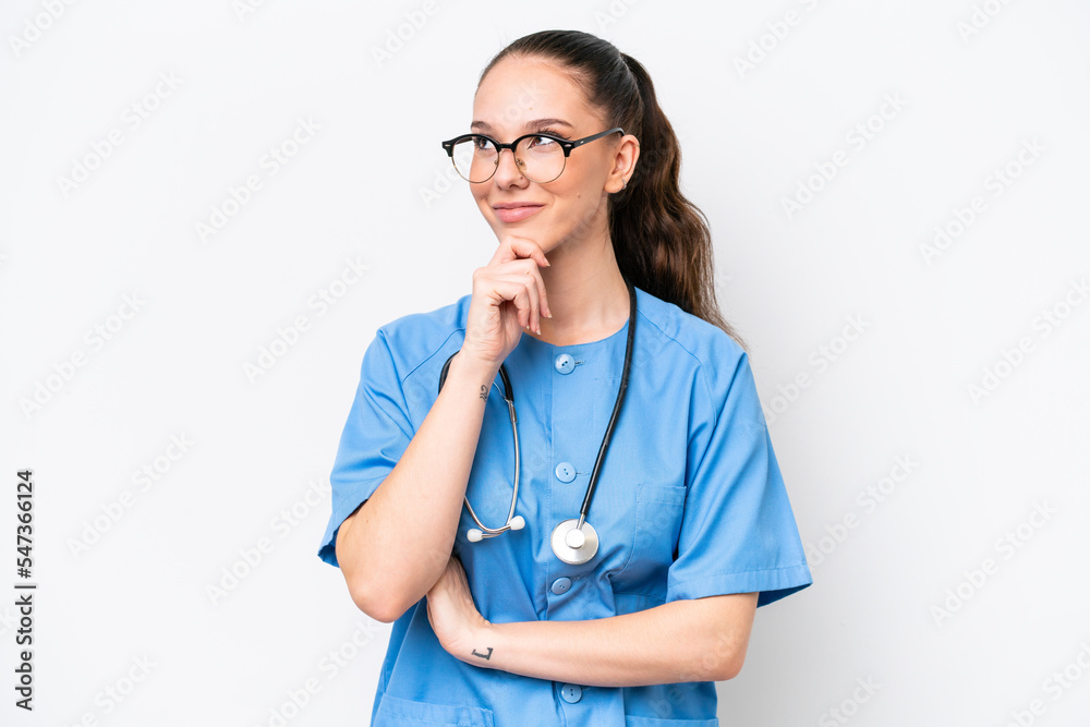 Young caucasian surgeon doctor woman isolated on white background looking to the side Young caucasian surgeon doctor woman isolated on white background looking to the side