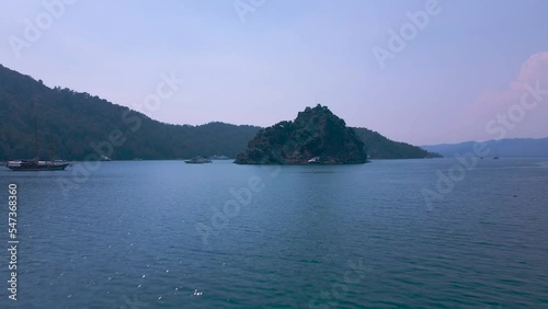 Beautiful seashore. Islands in the distance. Colorful blue sea. The beauty of Turkey. Beautiful rocks and mountains. Sunny clear day. Beautiful water.	