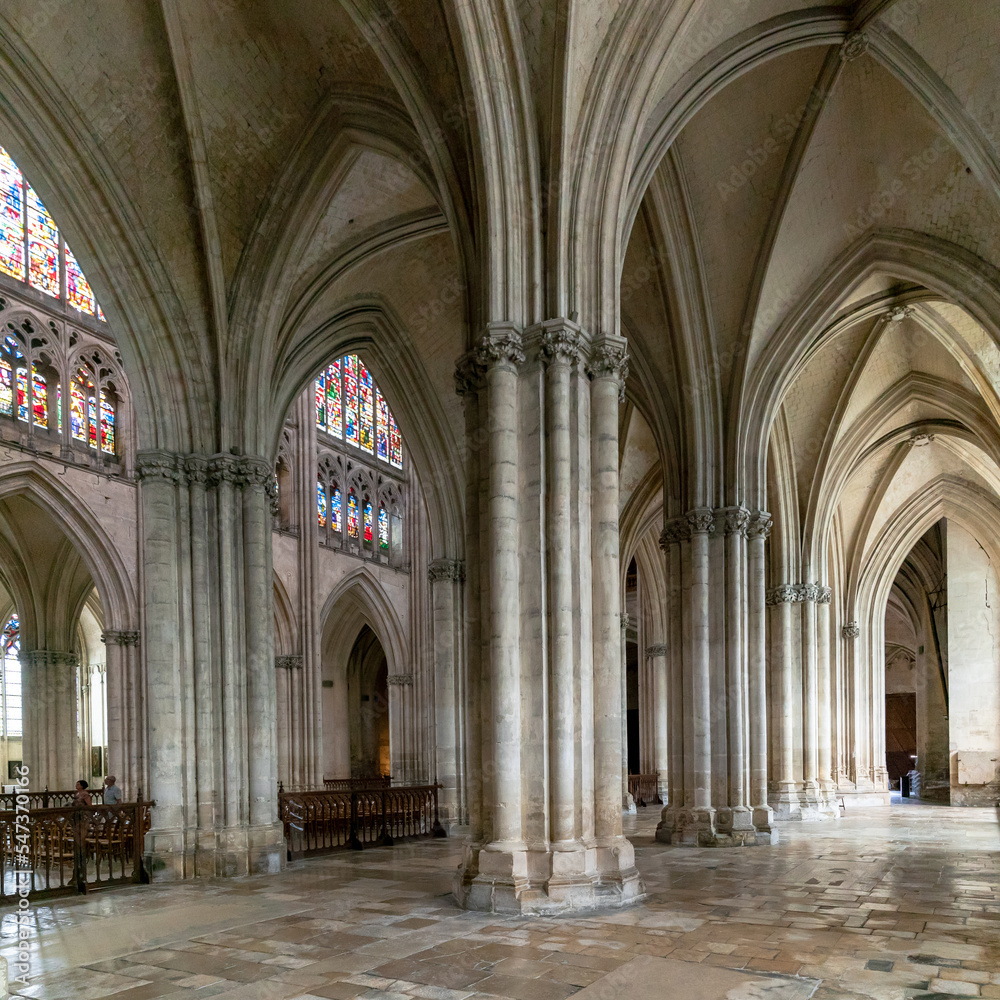 interior view of the Troyes Cathedral with side and central nave and stained glass windows