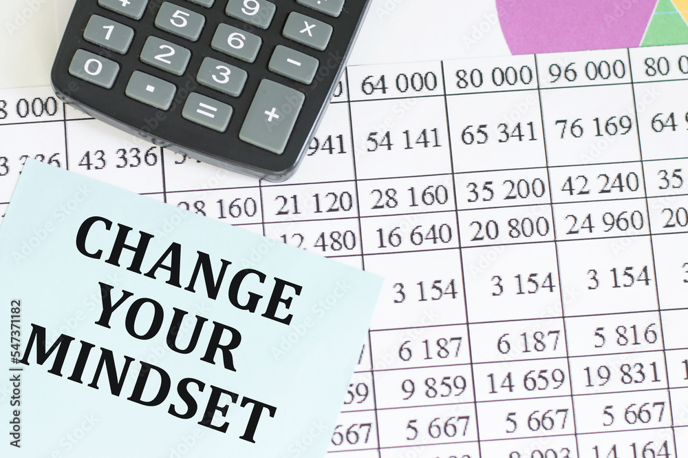 Change Your mindset text on a card against the background of difframs and reports on the table Change Your mindset text on a card against the background of difframs and reports on the table