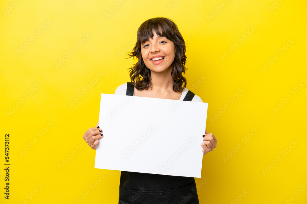 Restaurant waiter latin woman isolated on yellow bakcground holding an empty placard with happy expression Restaurant waiter latin woman isolated on yellow bakcground holding an empty placard with happy expression
