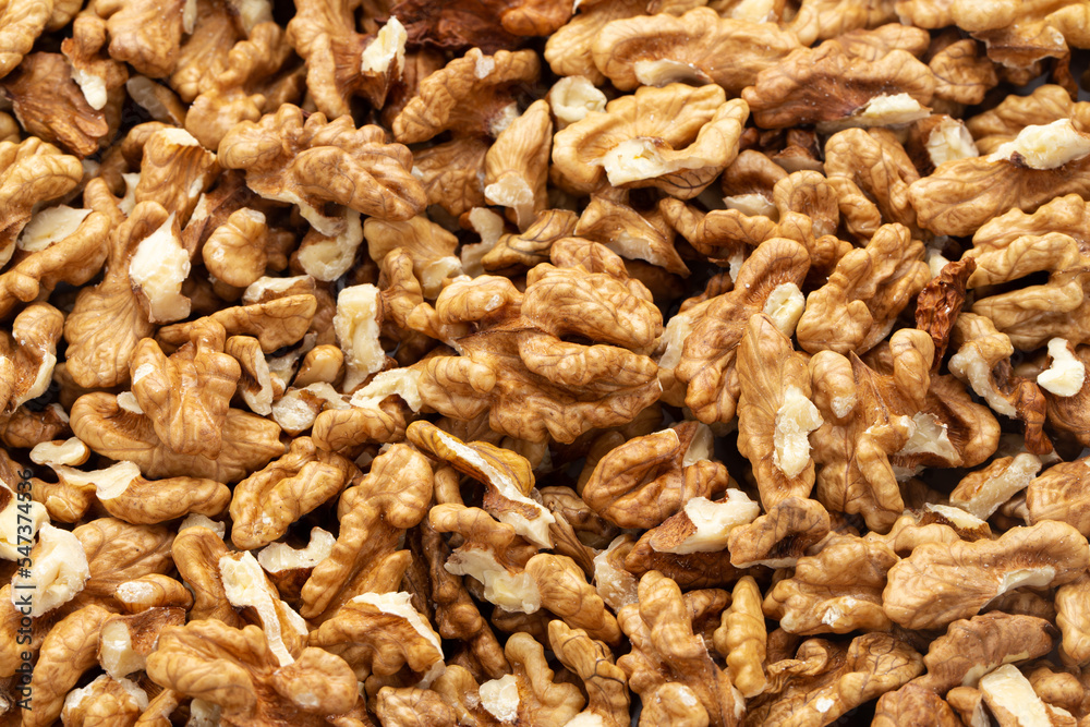Closeup of big shelled walnuts pile. Nuts are a source of vegetable protein. Closeup of big shelled walnuts pile. Nuts are a source of vegetable protein.