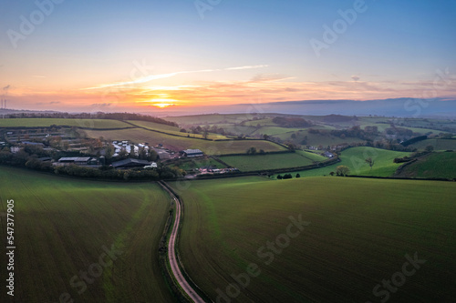 Sunset over fields and farms from a drone, Devon, England, Europe