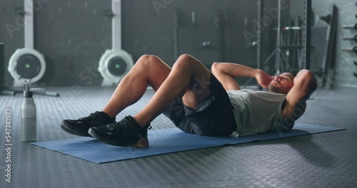 Exercise, man crunch training and fitness body workout in gym. Young Asian person athlete, healthy sports wellness goal and core muscle or abdomen power motivation and sit up on mat in health studio