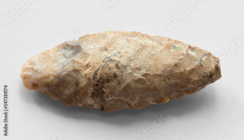 Flint arrowhead on white background photo